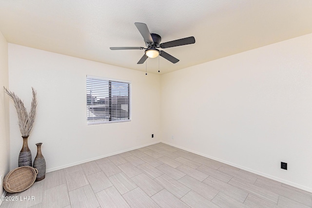 unfurnished room featuring baseboards and a ceiling fan