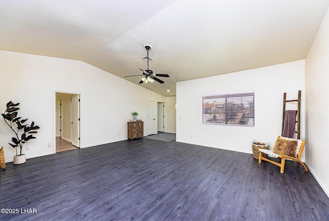 unfurnished room featuring dark wood-type flooring, baseboards, a ceiling fan, and lofted ceiling