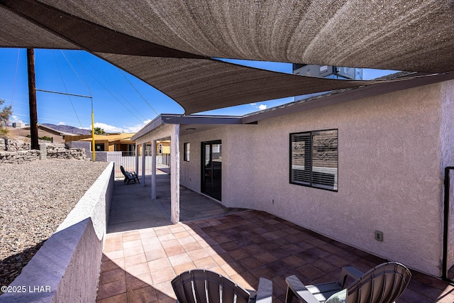 view of patio featuring fence