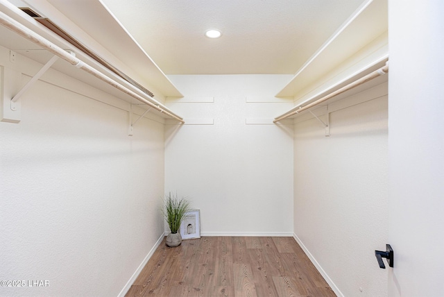 spacious closet with wood finished floors