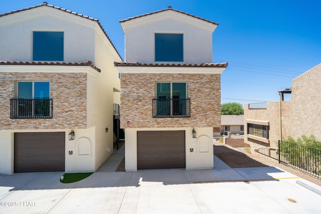 mediterranean / spanish-style home with a garage