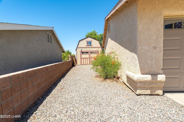 3841 Big Horn Dr, Lake Havasu City, AZ 86406 - view of property exterior with stucco siding and a storage shed