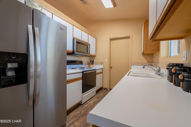 3841 Big Horn Dr, Lake Havasu City, AZ 86406 - kitchen with stainless steel appliances, light countertops, dark wood-type flooring, and white cabinetry