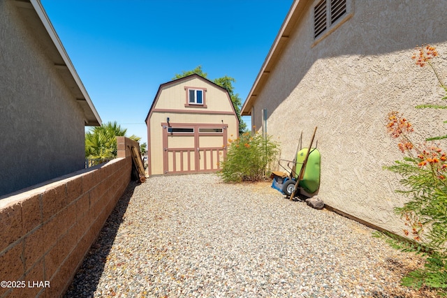 3841 Big Horn Dr, Lake Havasu City, AZ 86406 - view of property exterior featuring a shed, stucco siding, and a gambrel roof