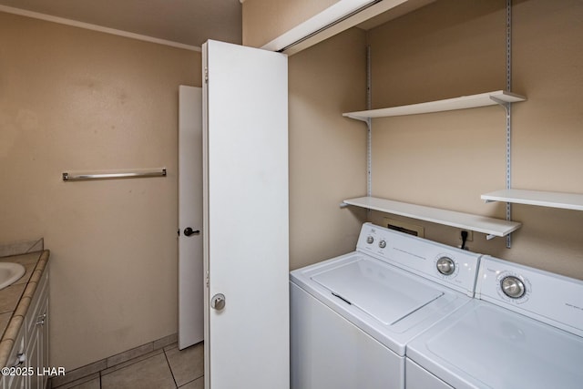 laundry room featuring separate washer and dryer and light tile patterned floors