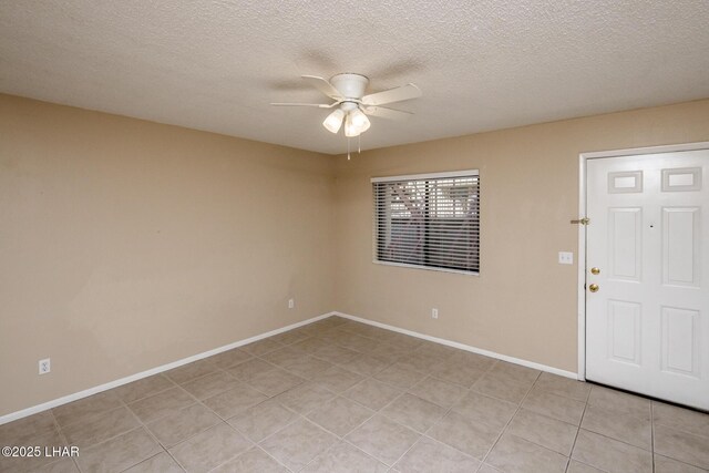 empty room with light tile patterned floors, a textured ceiling, and ceiling fan