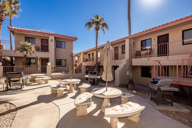 view of community with an outdoor fire pit and a patio area