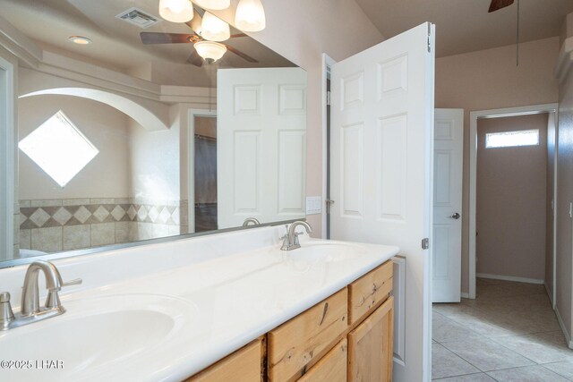 bathroom with tile patterned flooring, vanity, and ceiling fan