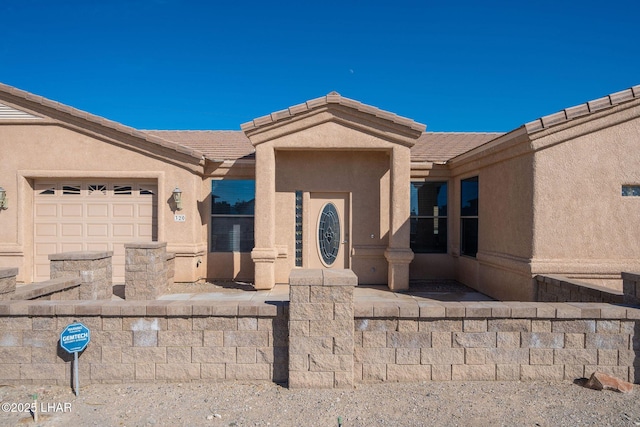 doorway to property with a garage