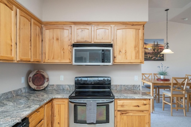 kitchen with appliances with stainless steel finishes, decorative light fixtures, and light brown cabinets