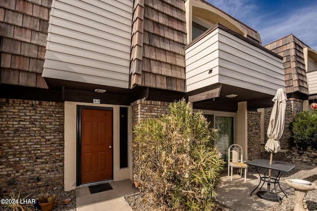 property entrance featuring a patio