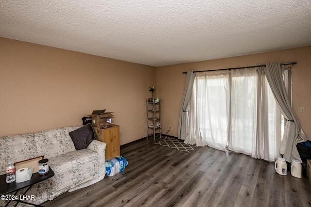 unfurnished room with dark hardwood / wood-style floors and a textured ceiling