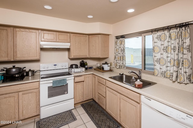 kitchen featuring sink, white appliances, light tile patterned floors, and light brown cabinets