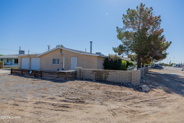 view of side of home featuring a garage