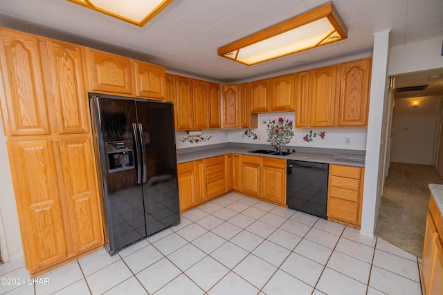 kitchen with sink, light tile patterned floors, and black appliances