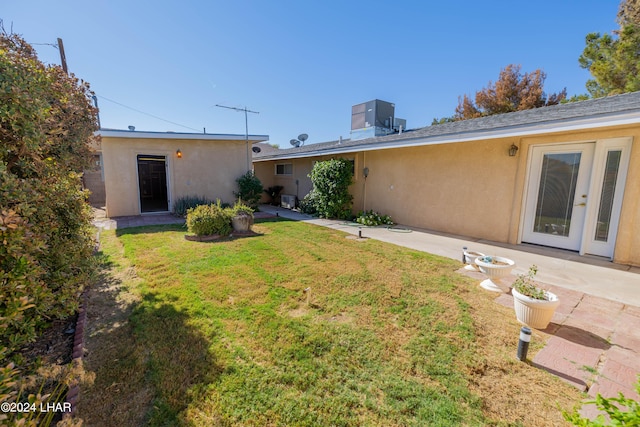 view of yard featuring central AC and a patio area