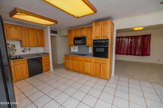 kitchen with light colored carpet and black appliances