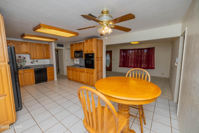 kitchen with black appliances, ceiling fan, and light tile patterned flooring