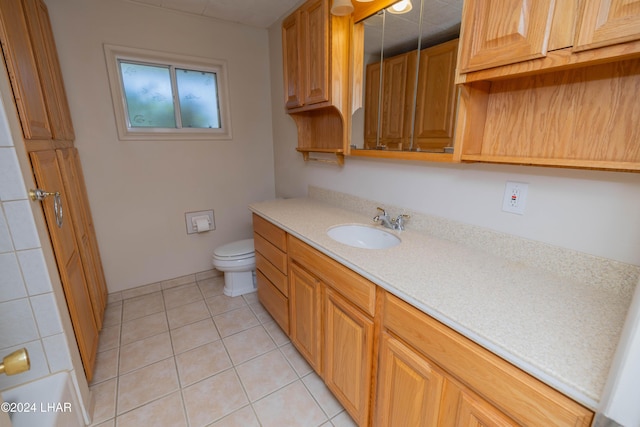 bathroom featuring tile patterned flooring, vanity, and toilet