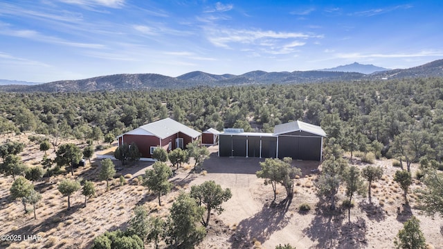 drone / aerial view featuring a forest view and a mountain view