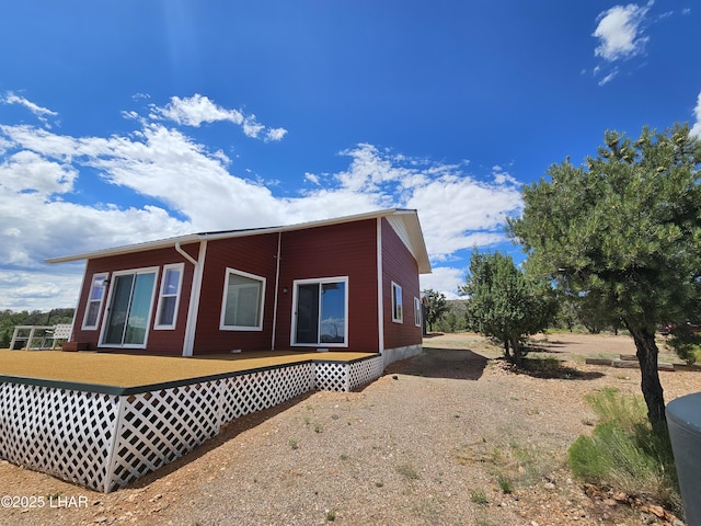 view of property exterior featuring a deck