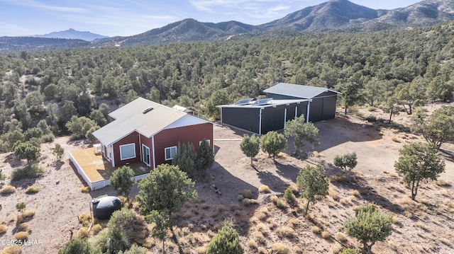 birds eye view of property with a mountain view and a view of trees