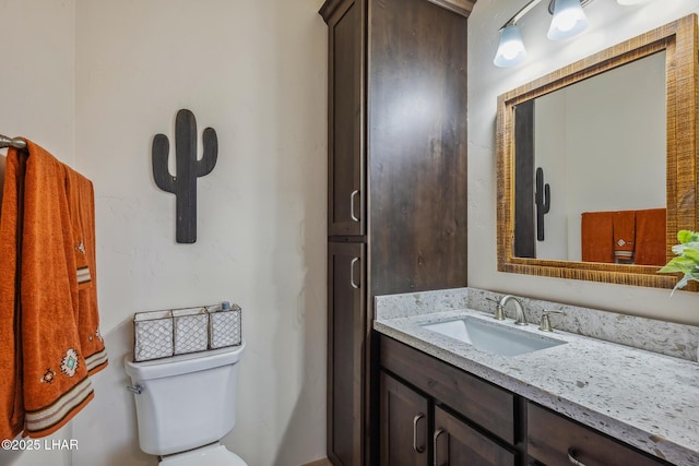 half bathroom with toilet and vanity