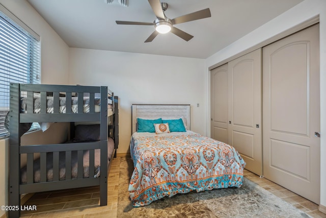 bedroom featuring a closet, ceiling fan, and wood tiled floor