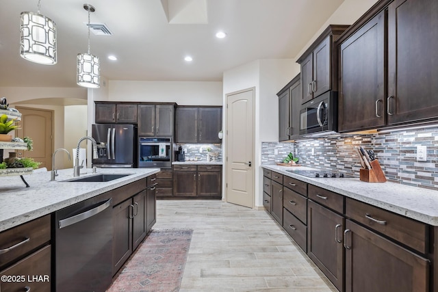 kitchen with a sink, stainless steel appliances, dark brown cabinetry, and visible vents