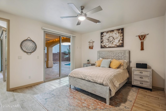 bedroom with light wood-type flooring, baseboards, and access to outside