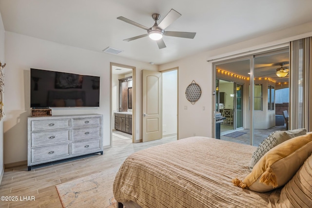 bedroom with light wood-type flooring, visible vents, ensuite bathroom, and a ceiling fan