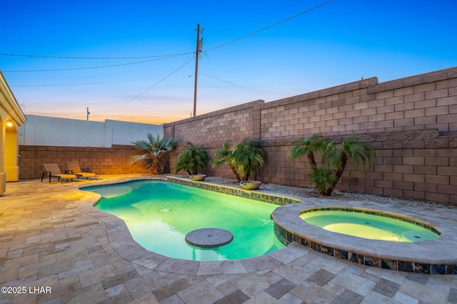 view of swimming pool featuring a patio area, a fenced in pool, an in ground hot tub, and a fenced backyard