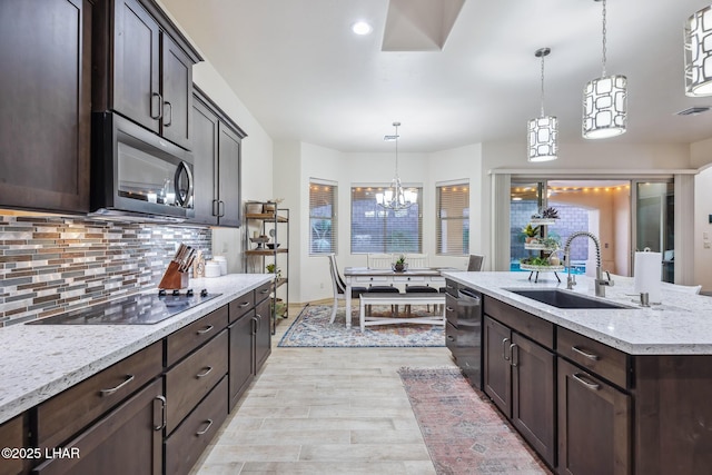 kitchen featuring a sink, stainless steel microwave, black electric cooktop, dark brown cabinets, and dishwasher