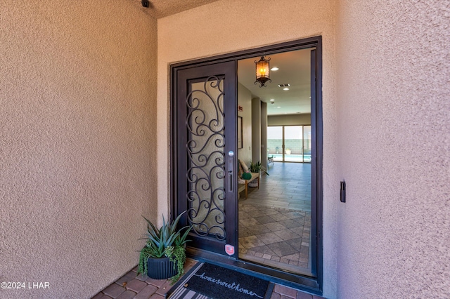 property entrance with stucco siding
