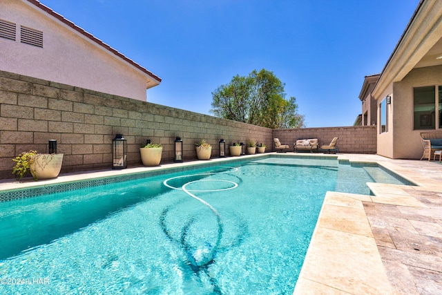 view of pool featuring a fenced in pool, a patio area, and a fenced backyard