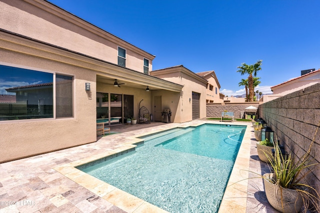 view of swimming pool featuring a fenced in pool, a patio, a fenced backyard, and ceiling fan