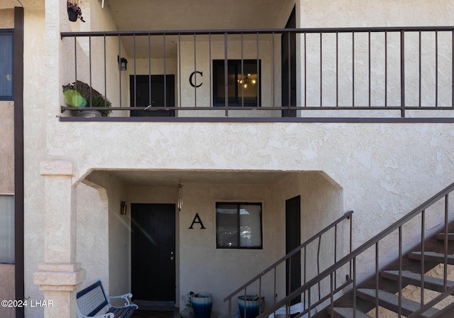 view of exterior entry featuring a balcony