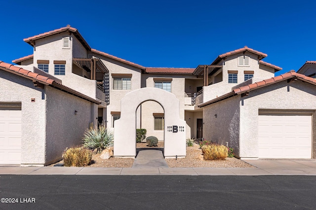 view of front of property with a garage and a balcony