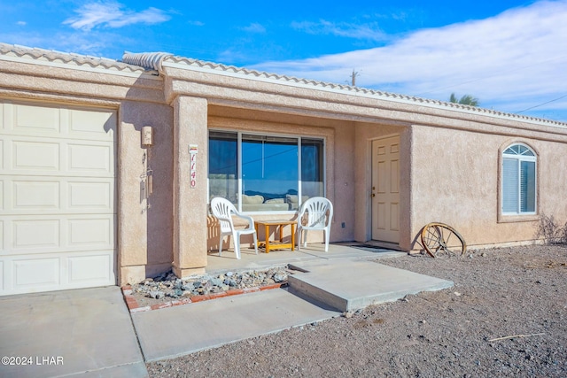 view of exterior entry with a garage