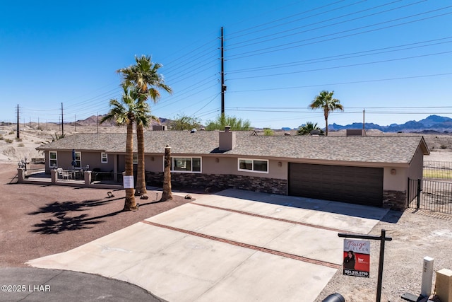 881 Bryce Ct, Lake Havasu City, AZ 86406 - ranch-style house featuring driveway, a garage, stucco siding, stone siding, and a mountain view