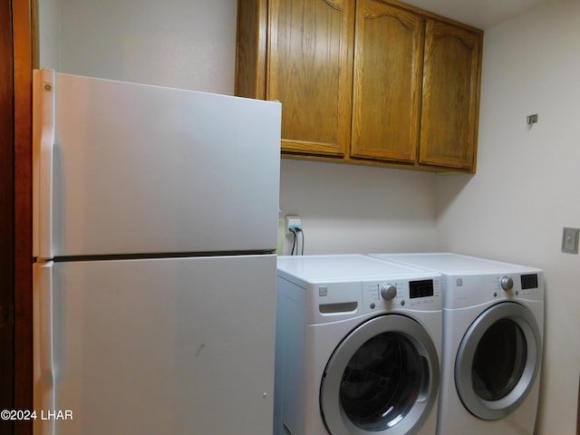 laundry room with cabinets and washer and clothes dryer