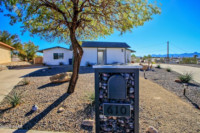 exterior space with a mountain view and fence