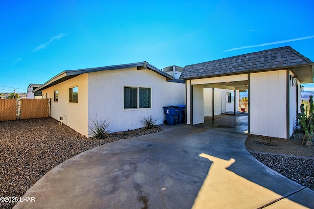 610 Roamer Ln, Lake Havasu City, AZ 86403 - rear view of house with roof with shingles, driveway, and fence