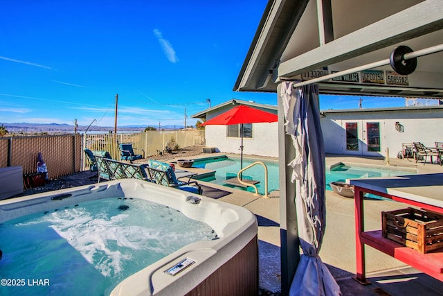 610 Roamer Ln, Lake Havasu City, AZ 86403 - view of swimming pool featuring a patio, a fenced in pool, a fenced backyard, a hot tub, and french doors