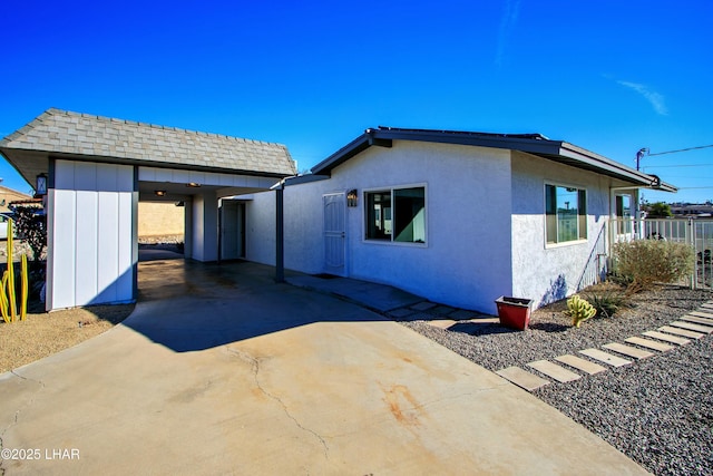 610 Roamer Ln, Lake Havasu City, AZ 86403 - view of front of house with concrete driveway, roof with shingles, and stucco siding