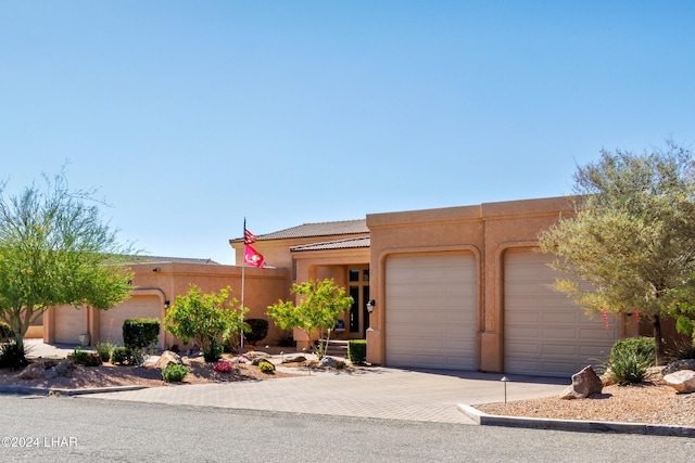 adobe home featuring a garage