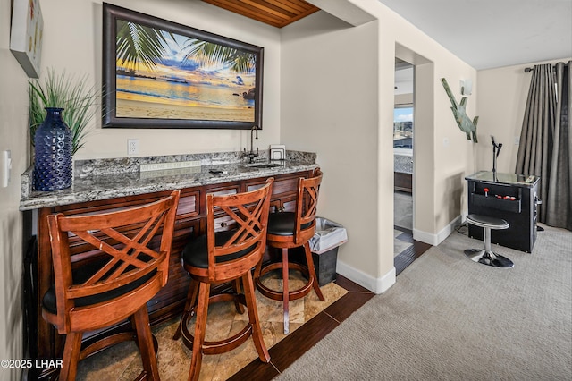 8652 Hopi Dr, Parker, AZ 85344 - indoor wet bar featuring carpet flooring and baseboards