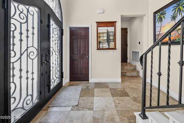 8652 Hopi Dr, Parker, AZ 85344 - foyer with stairs, stone tile flooring, and a high ceiling