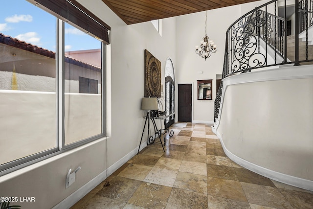 8652 Hopi Dr, Parker, AZ 85344 - entrance foyer featuring stone tile flooring, stairs, a chandelier, and wood ceiling