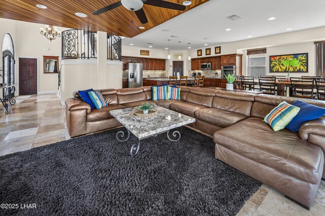 8652 Hopi Dr, Parker, AZ 85344 - living room featuring recessed lighting, ceiling fan, a chandelier, light tile patterned flooring, and wooden ceiling